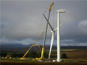 A Liebherr LTM 1500 crane lifting the full blade assembly of a Siemens 2.3 MW wind turbine into place in Ireland